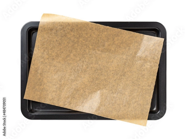 Fototapeta Baking sheet with brown parchment paper isolated on a white background. Empty oven tray for baking and roasting. Rectangular baking pan for food design. Nonstick kitchen utensils.