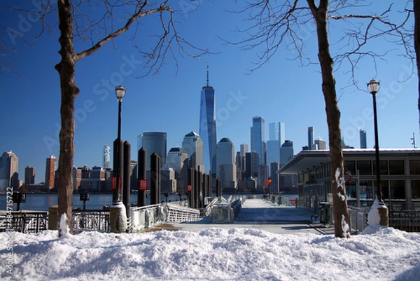 Fototapeta Downtown Manhattan and the Freedom tower with a ferry dock and the snow