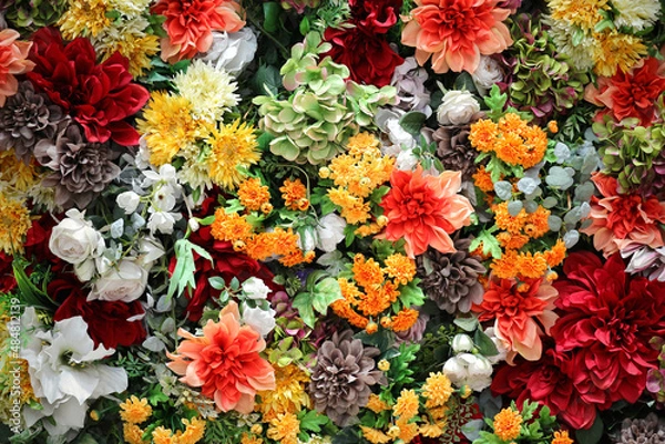 Obraz Photo for background material of colorful wall decorated with many artificial flowers