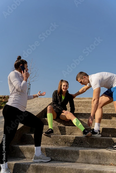 Fototapeta Helping her with the injury on the stairs