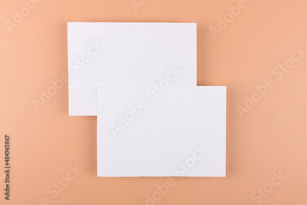 Obraz Card mockup of two empty white 5x7 card invitations on beige or terracotta nude background. Minimal simple functional background design with neutral colors