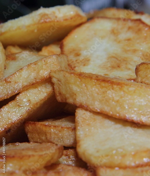 Obraz Fried potato. Culinary dish. Cooking process. Deep-fried cooking.