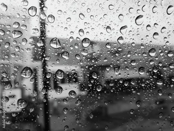 Fototapeta Raindrops that stick to the windshield of the car, when the rain just subsided in the city of Medan. 