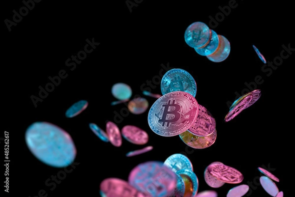 Obraz falling bitcoins with blue and pink light on dark background