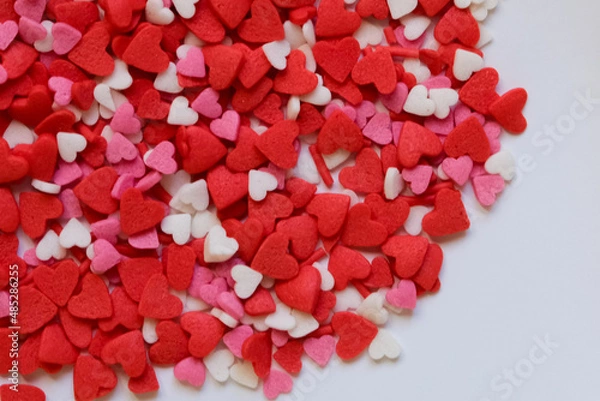 Fototapeta sprinkle hearts on a white background with a place for text