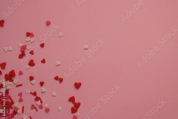 Fototapeta pink background with sprinkles hearts with space for text