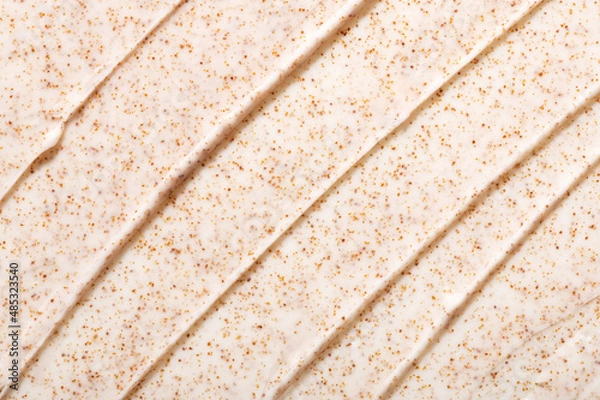 Obraz Smears of natural facial scrub with orange grains professional salon skincare product as background close view from above