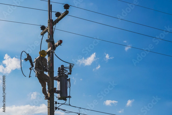 Fototapeta The silhouette of power lineman replacing a transformer and hotline clamp, bail  clamp. Using clamp stick grip all type, wearing personal protective equipmen,