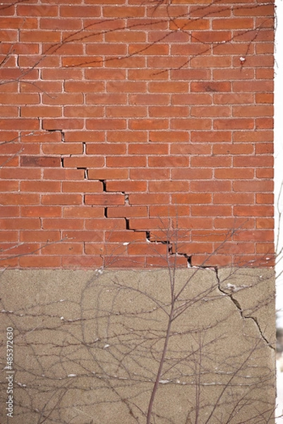 Fototapeta Red Brick Wall and Foundation with Large Crack and crumbling mortar
