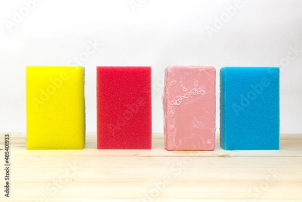Fototapeta Colorful sponges and soap on a white background.