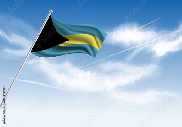 Fototapeta Flag of the Bahamas on a stick, clear sky in the background