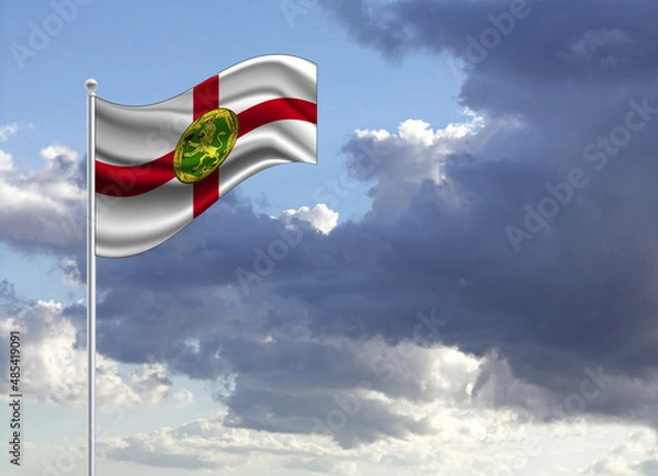 Fototapeta Flag of the Alderney on a stick, dark clouds in the background