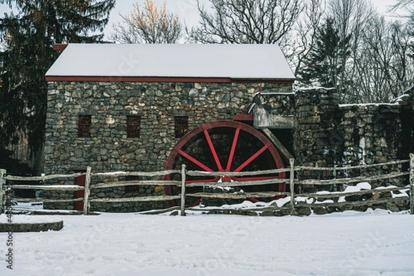 Fototapeta Old stone mill in the snow