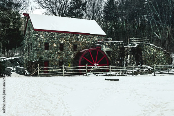 Fototapeta Old stone mill in the snow