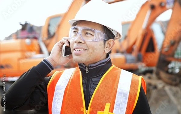 Obraz road construction worker in front of excavator