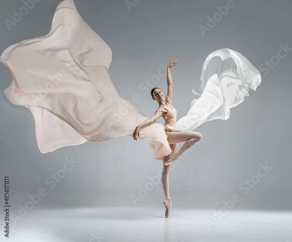 Fototapeta Beautiful ballerina dancing in the body color ballet leotard with body color cloth. She danced on ballet pointe shoes.