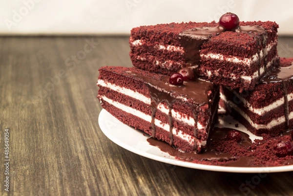 Fototapeta Cake with cranberries and cream on a wooden background.