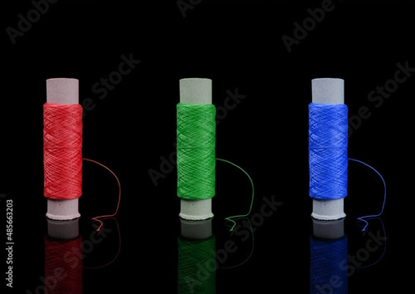 Obraz A skein of thread, a spool of thread for sewing, on a black background isolated with reflection