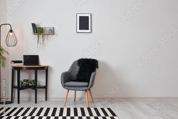 Fototapeta Stylish interior of minimalist room with modern workplace and laptop