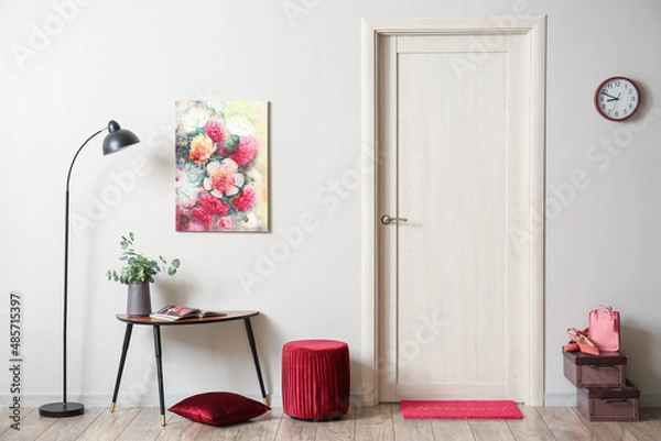 Fototapeta Interior of stylish hall with lamp, table and red pouf