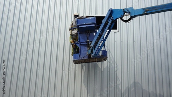 Fototapeta Workers are installing galvanized sheets.