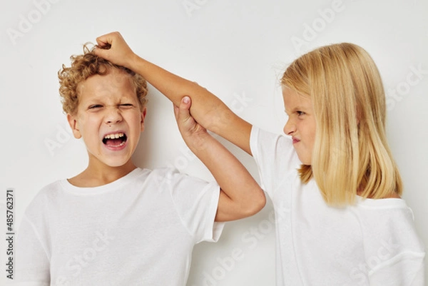Fototapeta Photo of two children in white T-shirts are standing next to childhood unaltered