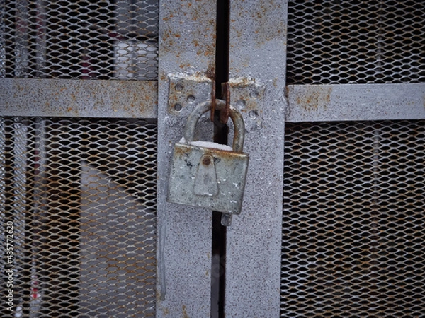 Fototapeta Texture of a gray metal grate with various elements