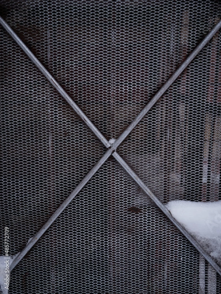 Fototapeta Texture of a gray metal grate with various elements