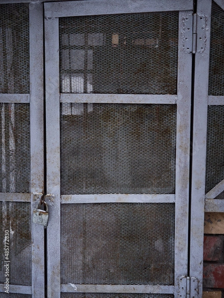 Fototapeta Texture of a gray metal grate with various elements