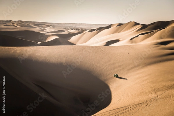 Obraz Dune buggying in sand dunes at sunset in the desert at Huacachina, Ica Region, Peru, South America