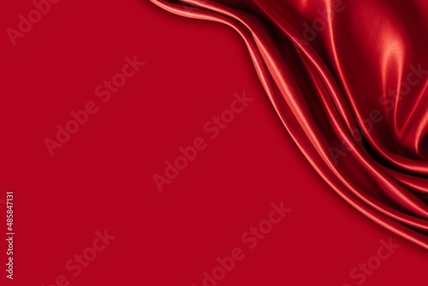Fototapeta Beautiful elegant wavy hot red satin silk luxury cloth fabric texture with monochrome background design. Wallpaper, banner or card with copy space.