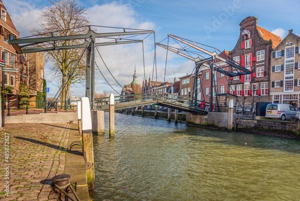 Fototapeta The Damiate Bridge in the historic center of the Dutch city of Dordrecht was built in 1857. The bridge over the water of an inland harbor connects two quays: the Wolwevershaven and the Kuipershaven.