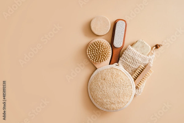 Fototapeta Flat lay composition with zero waste eco friendly cosmetics and bathroom accessories on beige background. Skin care concept. Face care routine. Hard soap and peeling accesories