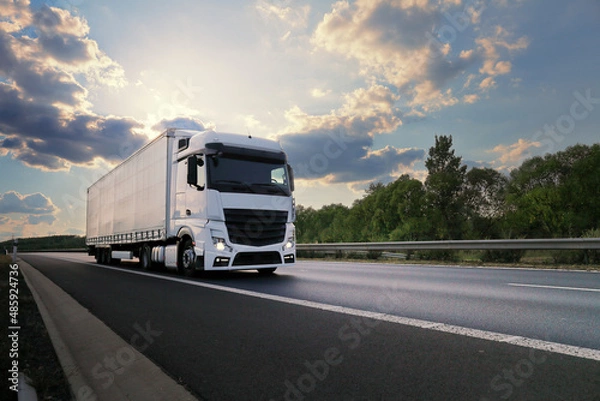 Obraz Landscape with a moving truck at sunset 