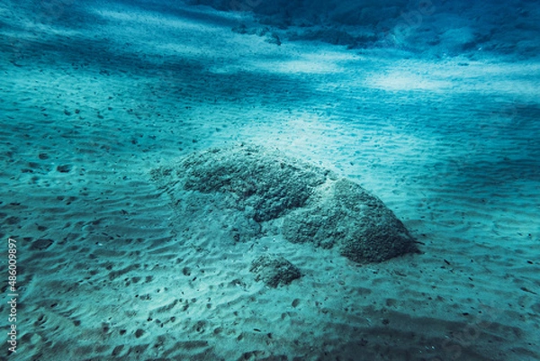 Obraz Underwater scene with rocks surrounded by sand