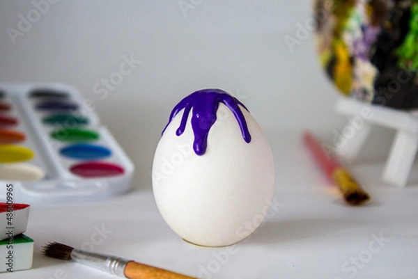 Fototapeta White Easter egg on a watercolor background. Simple holiday composition. Symbolism of the Easter egg festival concept. Art work, handmade, creativity with children for decoration for Easter