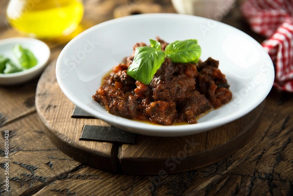 Fototapeta Homemade beef ragout with fresh basil