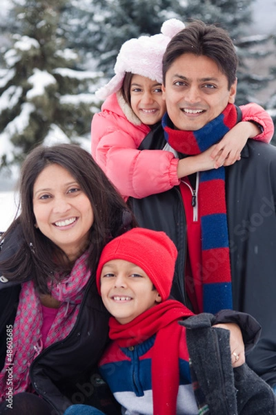 Obraz East Indian family playing in the snow