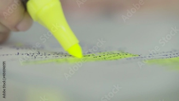 Fototapeta Marking an important text in a note with a yellow marker