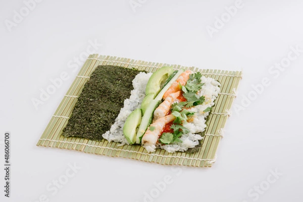 Obraz rolling sushi maki on a bamboo mat