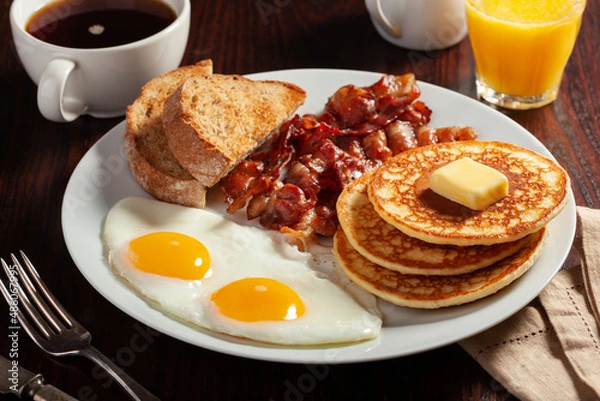 Fototapeta traditional full american breakfast eggs pancakes with bacon and toast