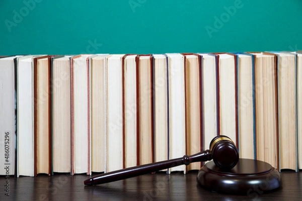 Fototapeta  law book with a wooden judges gavel on table