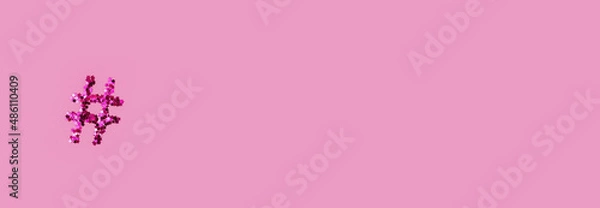 Obraz shiny hashtag on a light pink background. Online technology concept and social media marketing. Space for text and notes, copy, top view, flat lay.  Banner