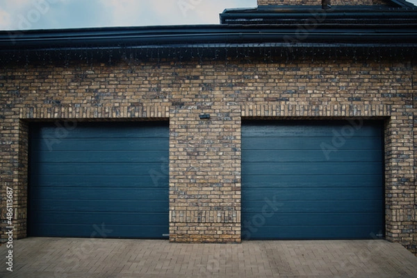 Obraz Garage Door. A double garage with blue doors at the end of a driveway