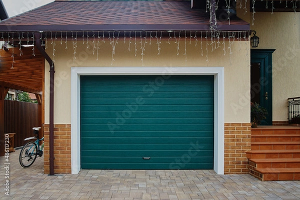 Obraz Garage Door. A garage with blue doors at the end of a driveway