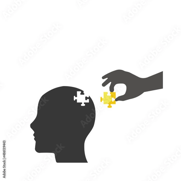 Fototapeta Puzzles in the form of a human head. The human hand inserts the missing puzzle into the head.