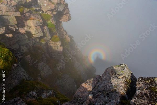 Fototapeta Brocken Spectre among the highest mountains in the fog and blue sky. Majestic scenery, Brocken bow or mountain spectre.