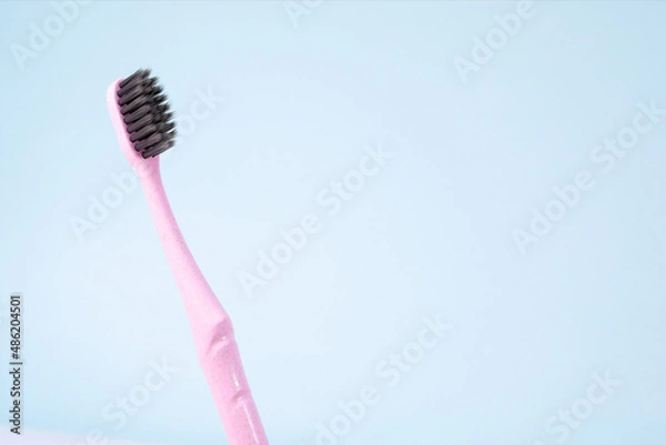 Fototapeta toothbrush isolated on blue background. Copy space