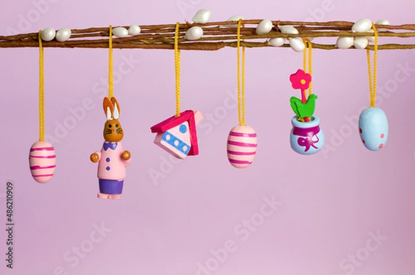 Obraz Easter decorations on a willow branch on a pink background with copyspace
