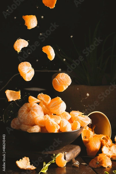 Obraz Juicy tangerines falling on dark backgorund